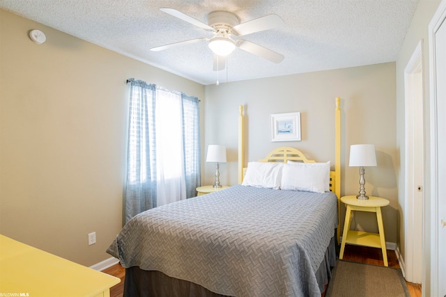 bedroom featuring a textured ceiling, ceiling fan, and hardwood / wood-style flooring