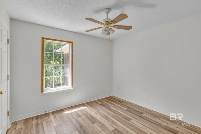 empty room featuring a textured ceiling, light hardwood / wood-style floors, and ceiling fan