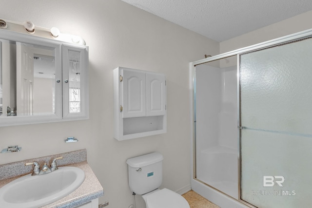 bathroom featuring walk in shower, a textured ceiling, vanity, and toilet