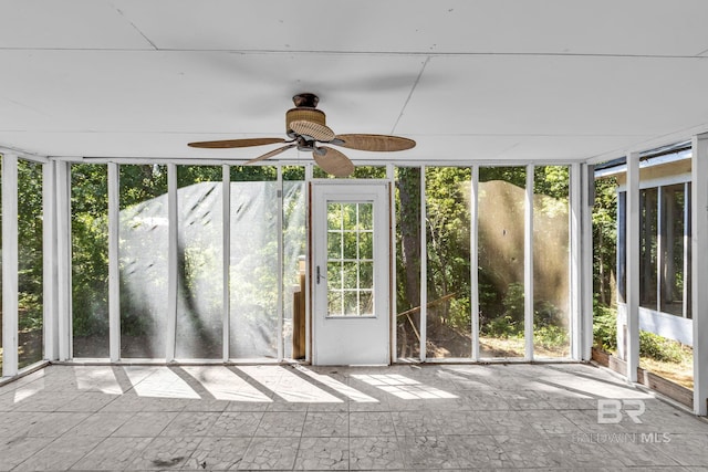 unfurnished sunroom with ceiling fan and a wealth of natural light