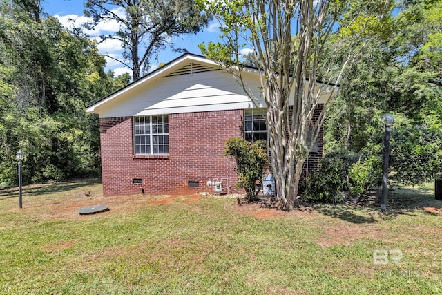 view of side of property with a yard