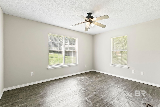 empty room with ceiling fan, a textured ceiling, and dark wood-type flooring