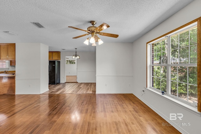 spare room featuring ceiling fan, a textured ceiling, light wood-type flooring, and sink