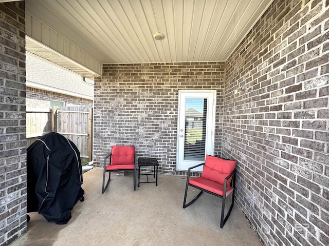 view of patio with grilling area and fence