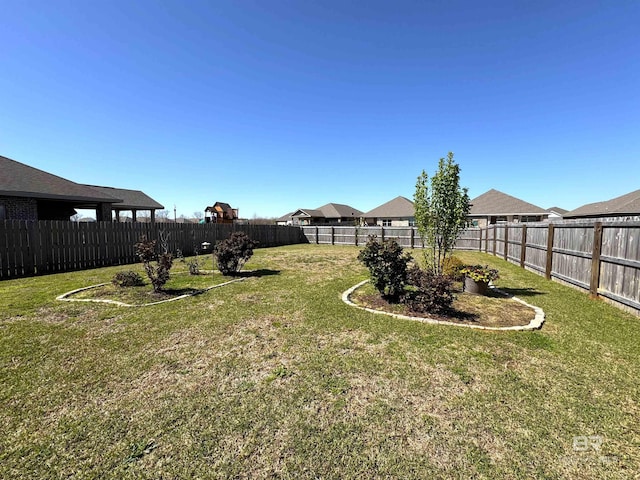 view of yard with a fenced backyard