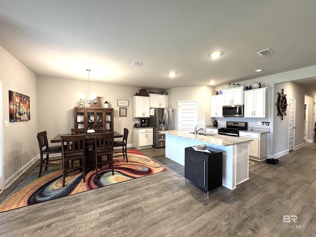 kitchen featuring stainless steel appliances, dark wood-type flooring, visible vents, and white cabinets