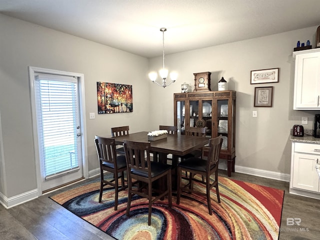 dining space with plenty of natural light, a notable chandelier, baseboards, and dark wood-style flooring