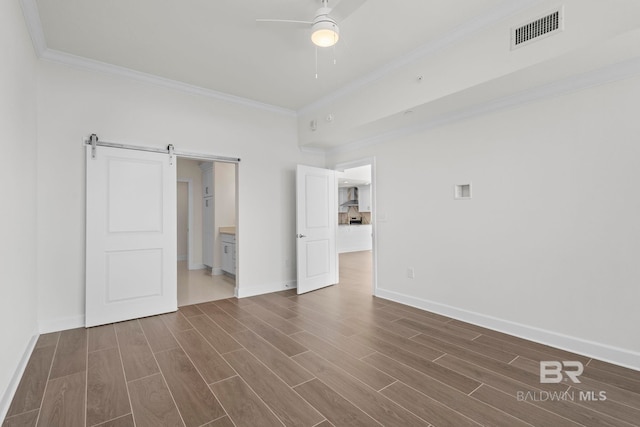 533 E Beach Blvd Unit 1905, Gulf Shores, AL 36542 - unfurnished bedroom featuring ornamental molding, a barn door, dark wood finished floors, baseboards, and a ceiling fan
