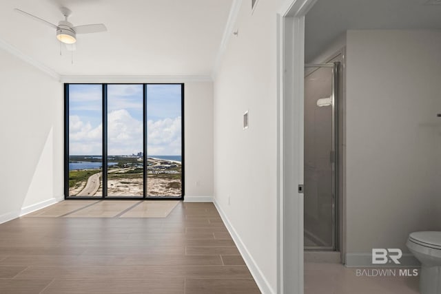 533 E Beach Blvd Unit 1905, Gulf Shores, AL 36542 - unfurnished bedroom with floor to ceiling windows, ornamental molding, baseboards, wood finished floors, and access to outside