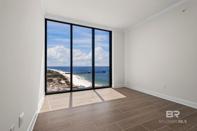 533 E Beach Blvd Unit 1905, Gulf Shores, AL 36542 - empty room featuring crown molding, floor to ceiling windows, a water view, dark wood-style floors, and baseboards
