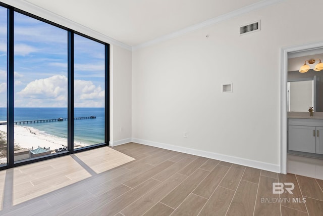 533 E Beach Blvd Unit 1905, Gulf Shores, AL 36542 - spare room featuring a water view, wood finished floors, ornamental molding, baseboards, and a sink