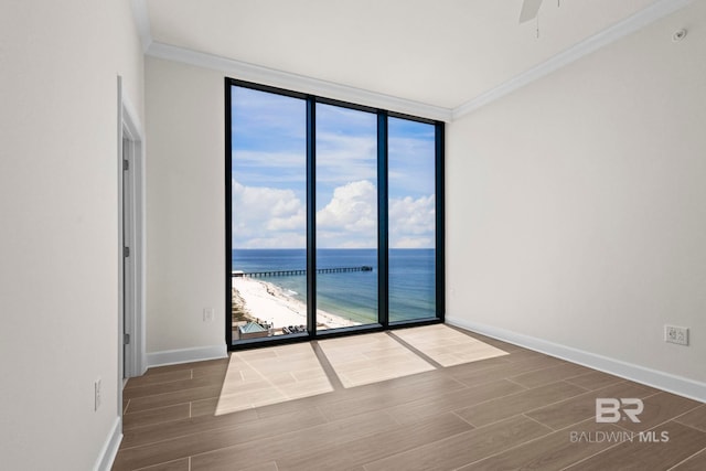 533 E Beach Blvd Unit 1905, Gulf Shores, AL 36542 - unfurnished room with a wall of windows, ornamental molding, wood finished floors, a water view, and a ceiling fan