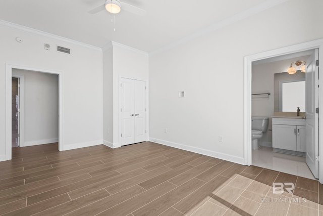 533 E Beach Blvd Unit 1905, Gulf Shores, AL 36542 - unfurnished bedroom with ornamental molding, baseboards, wood finished floors, and ensuite bathroom