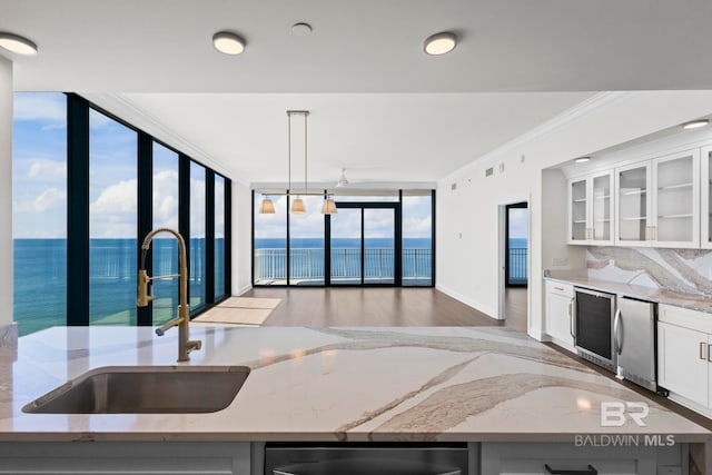 533 E Beach Blvd Unit 1905, Gulf Shores, AL 36542 - kitchen with a sink, a wall of windows, refrigerator, light stone countertops, and light wood-type flooring