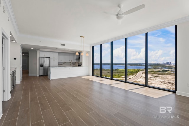 533 E Beach Blvd Unit 1905, Gulf Shores, AL 36542 - unfurnished living room featuring a water view, expansive windows, a ceiling fan, dark wood-style flooring, and crown molding
