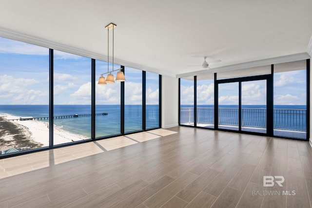 533 E Beach Blvd Unit 1905, Gulf Shores, AL 36542 - spare room with a wall of windows, ceiling fan, a water view, wood finished floors, and healthy amount of natural light