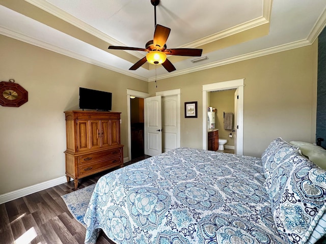 1030 Crown Walk Dr, Foley, AL 36535 - bedroom with dark wood finished floors, crown molding, ensuite bath, a ceiling fan, and a tray ceiling