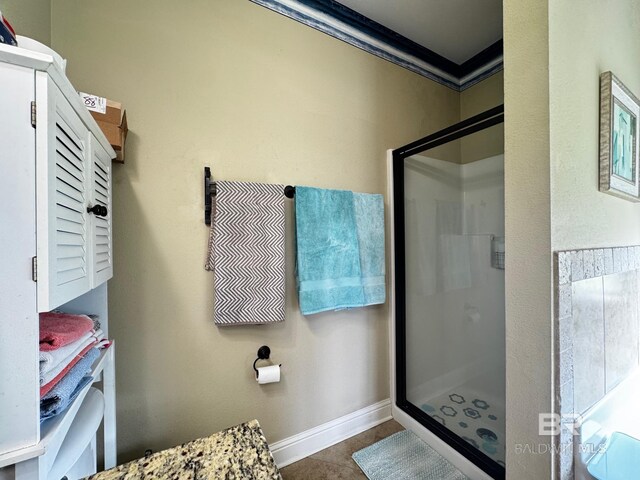 1030 Crown Walk Dr, Foley, AL 36535 - bathroom featuring a stall shower, crown molding, and tile patterned flooring