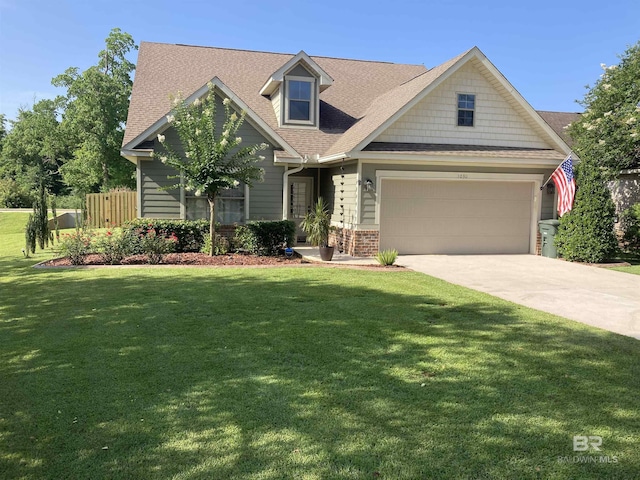1030 Crown Walk Dr, Foley, AL 36535 - view of front facade with concrete driveway, a front lawn, roof with shingles, and brick siding