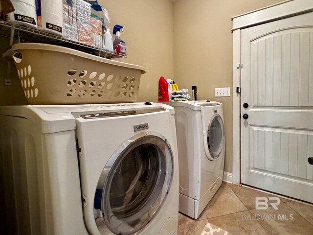 1030 Crown Walk Dr, Foley, AL 36535 - washroom with washing machine and dryer and light tile patterned flooring