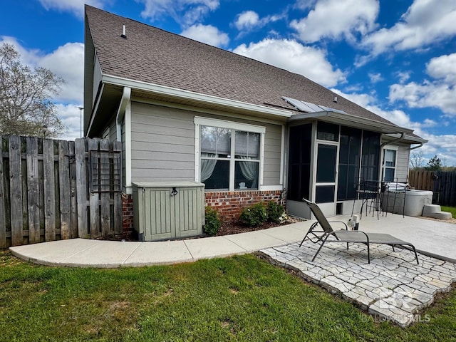 1030 Crown Walk Dr, Foley, AL 36535 - back of house with a sunroom, a patio, roof with shingles, and brick siding