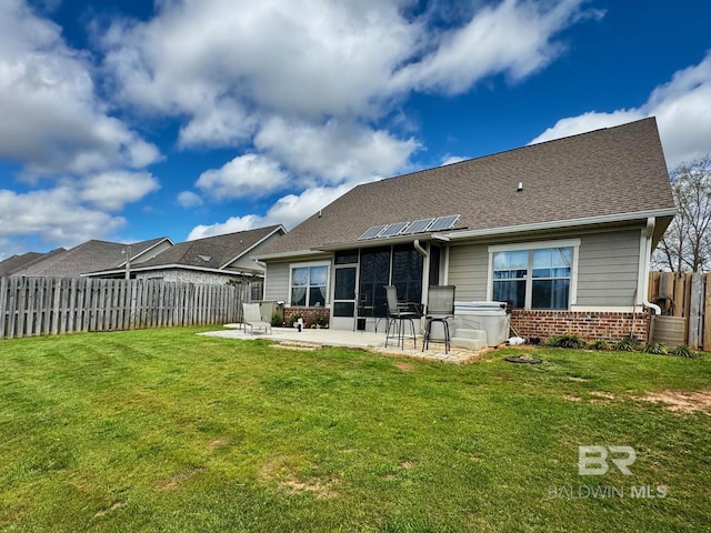 1030 Crown Walk Dr, Foley, AL 36535 - rear view of house featuring a patio area, brick siding, solar panels, a fenced backyard, and a sunroom