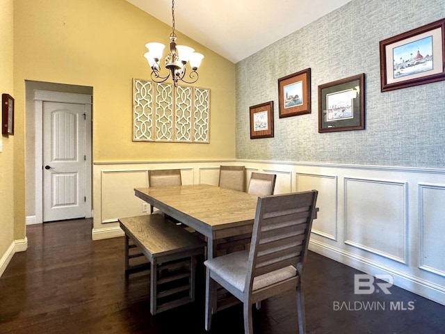 1030 Crown Walk Dr, Foley, AL 36535 - dining room with lofted ceiling, a chandelier, a wainscoted wall, dark wood-type flooring, and a decorative wall