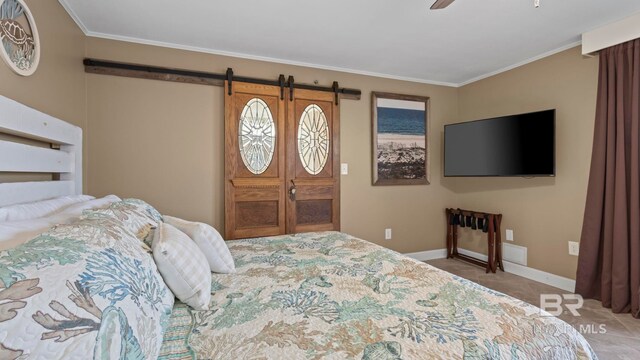 24132 Perdido Beach Blvd Unit 1011, Orange Beach, AL 36561 - carpeted bedroom featuring a barn door, baseboards, ornamental molding, and ceiling fan