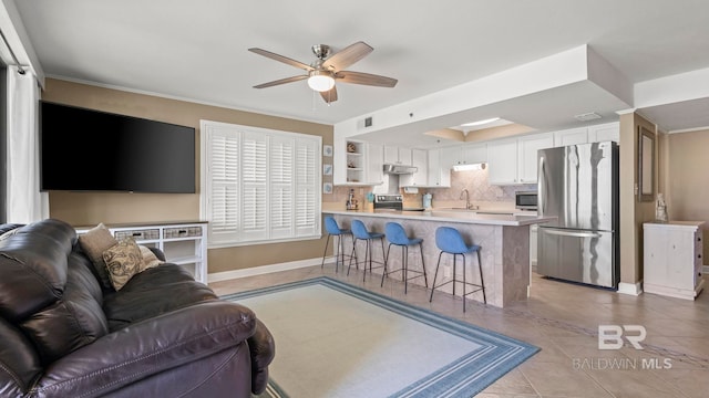 24132 Perdido Beach Blvd Unit 1011, Orange Beach, AL 36561 - living room with a ceiling fan, light tile patterned floors, baseboards, healthy amount of natural light, and crown molding