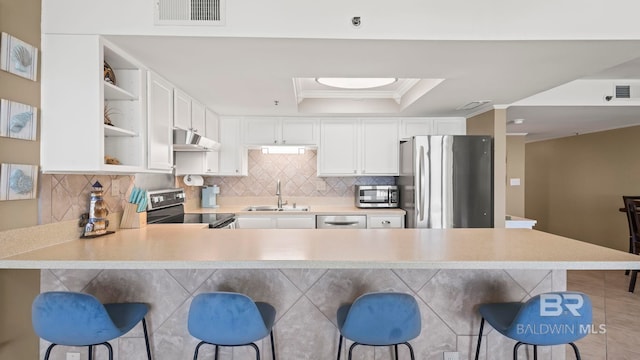 24132 Perdido Beach Blvd Unit 1011, Orange Beach, AL 36561 - kitchen with stainless steel appliances, ventilation hood, a sink, open shelves, and a breakfast bar