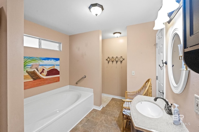 bathroom featuring vanity, tile patterned floors, and a tub