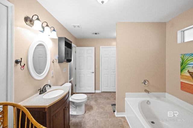 bathroom with a tub to relax in, tile patterned floors, vanity, and toilet