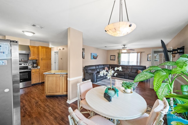 dining area featuring dark hardwood / wood-style flooring and ceiling fan