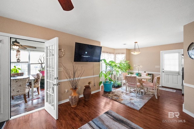 dining room with ceiling fan, french doors, and dark hardwood / wood-style floors