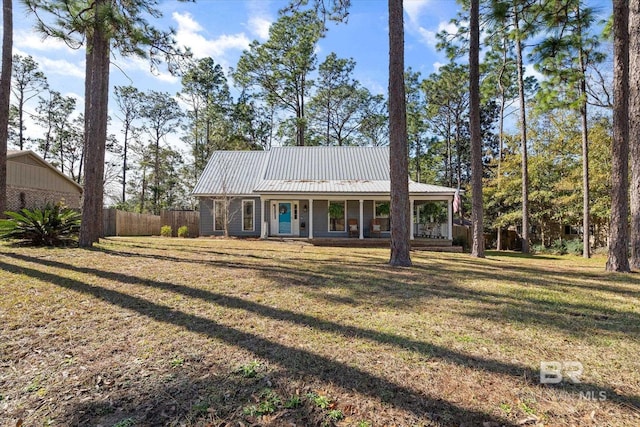 ranch-style home with a front yard and covered porch