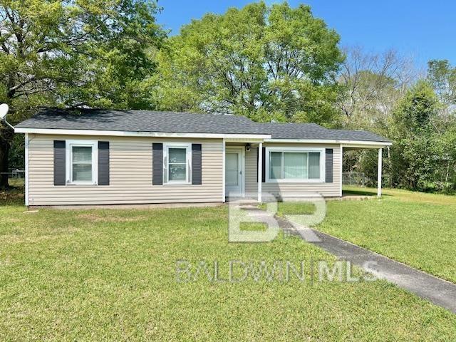 507 E Pine St, Atmore, AL 36502 - ranch-style house with a front lawn and roof with shingles