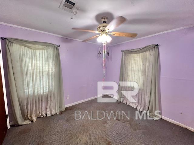 507 E Pine St, Atmore, AL 36502 - unfurnished bedroom featuring baseboards, carpet floors, visible vents, and crown molding
