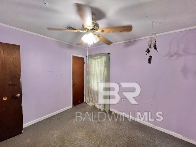 507 E Pine St, Atmore, AL 36502 - interior space featuring baseboards, ornamental molding, a ceiling fan, and carpet