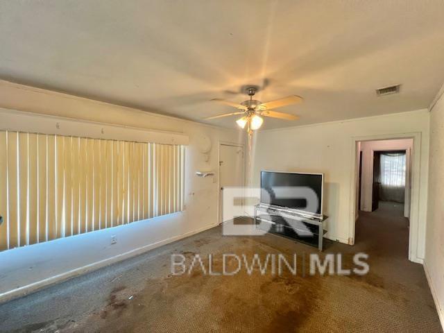 507 E Pine St, Atmore, AL 36502 - unfurnished living room featuring a ceiling fan and visible vents