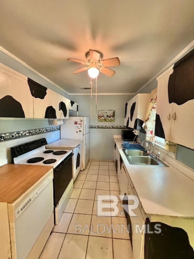 507 E Pine St, Atmore, AL 36502 - kitchen with crown molding, a sink, electric range oven, white dishwasher, and light tile patterned floors
