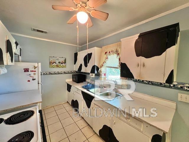 507 E Pine St, Atmore, AL 36502 - kitchen with crown molding, a sink, light tile patterned floors, white appliances, and visible vents
