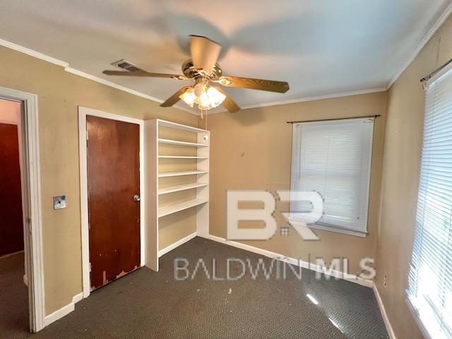 507 E Pine St, Atmore, AL 36502 - unfurnished bedroom featuring ornamental molding, carpet, baseboards, and visible vents