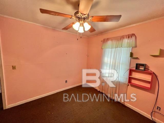 507 E Pine St, Atmore, AL 36502 - unfurnished bedroom with baseboards, carpet flooring, a ceiling fan, and crown molding