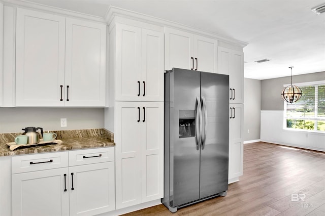 kitchen with white cabinetry, dark stone countertops, light wood-type flooring, and stainless steel fridge with ice dispenser