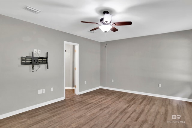 empty room featuring ceiling fan and hardwood / wood-style floors