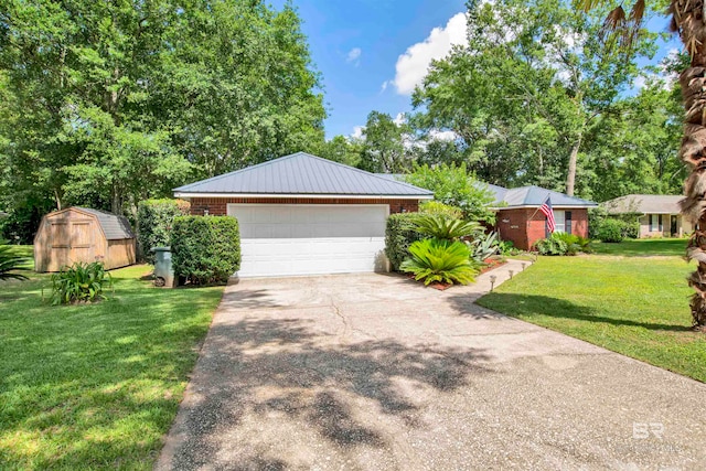 view of front of property with a garage, a storage shed, and a front yard