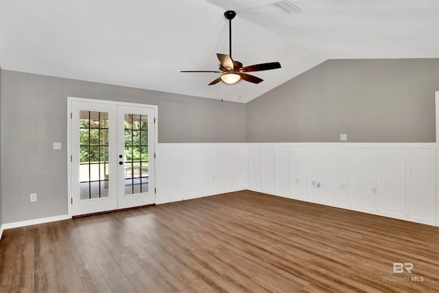 spare room featuring french doors, lofted ceiling, wood-type flooring, and ceiling fan