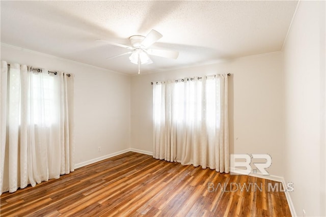 spare room with hardwood / wood-style flooring, ceiling fan, crown molding, and a textured ceiling