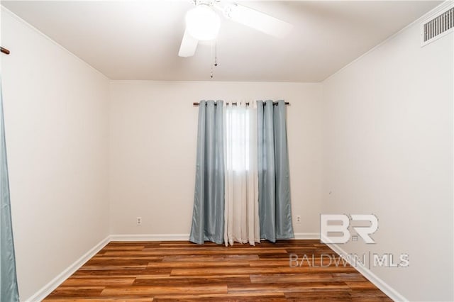 empty room featuring ceiling fan, wood-type flooring, and ornamental molding