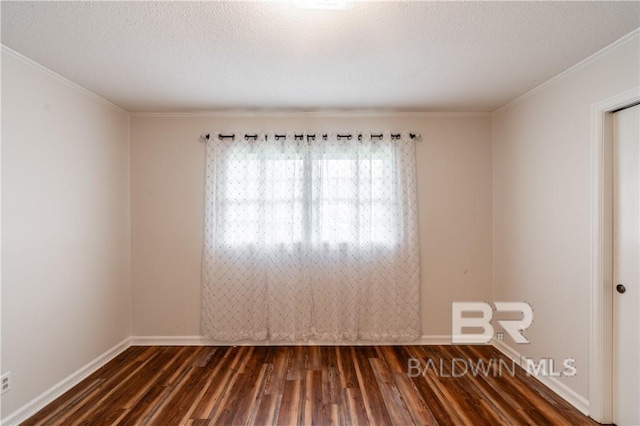 spare room featuring a textured ceiling, dark hardwood / wood-style flooring, and crown molding